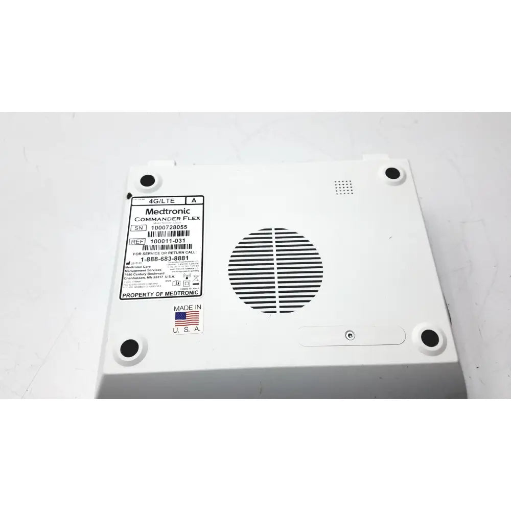 White plastic medtronics commander flex 100011-031 medical device back with circular vent grille and four black mounting holes