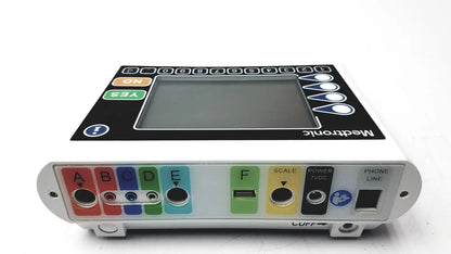 White medtronics commander flex medical infusion pump with black control panel and colorful labeled ports and buttons