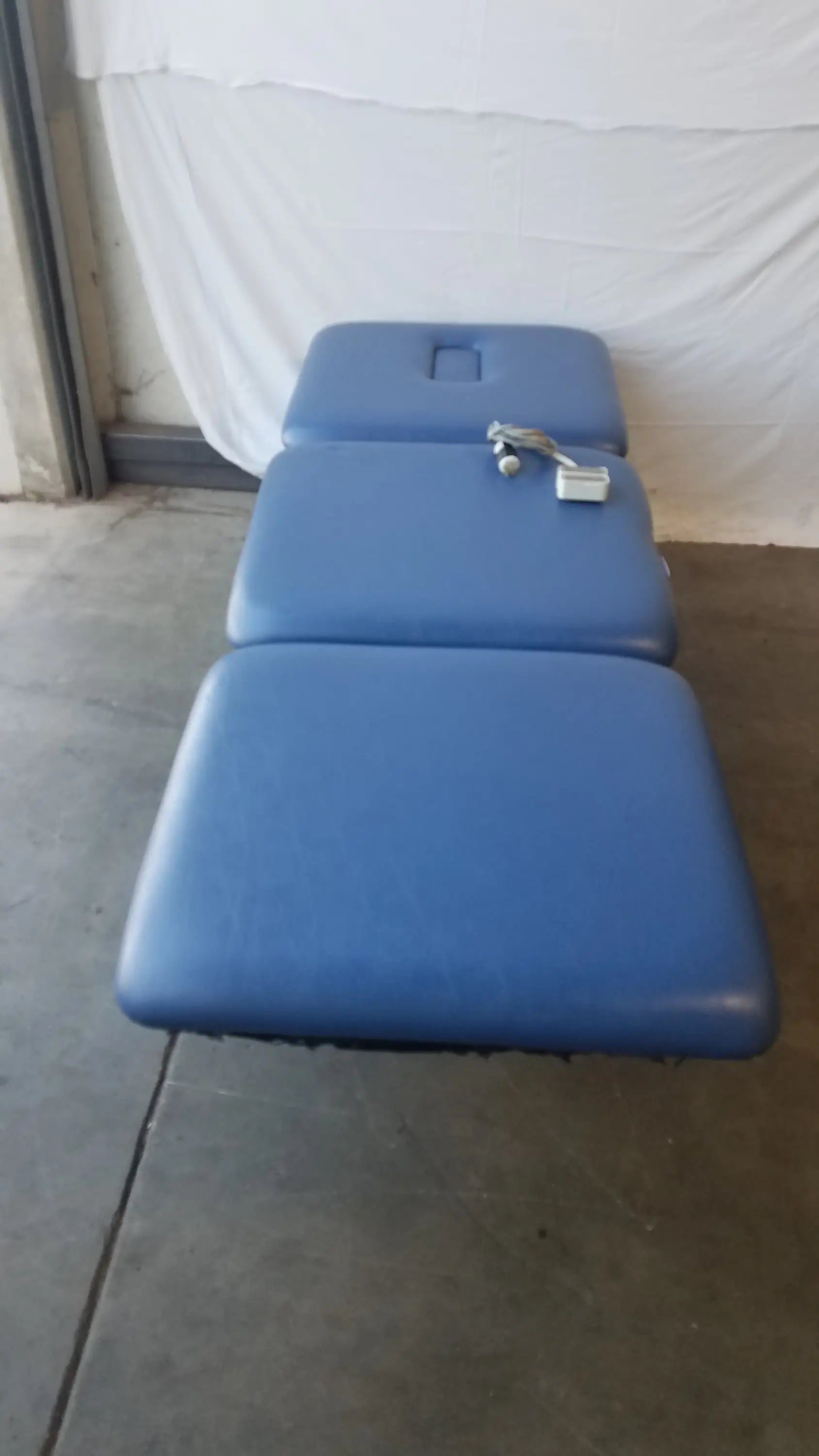 Blue padded metron 3-section electric treatment table with segmented sections and control unit for electric treatment