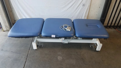 Blue three-section electric treatment table with white metal frame and casters for adjustable electric treatment use