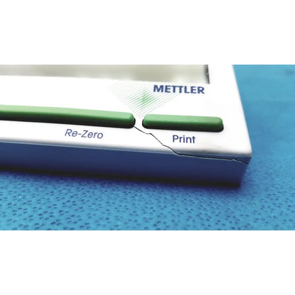 White and green mettler bb1200 digital scale with a visible crack along its side for precise electronic weighing