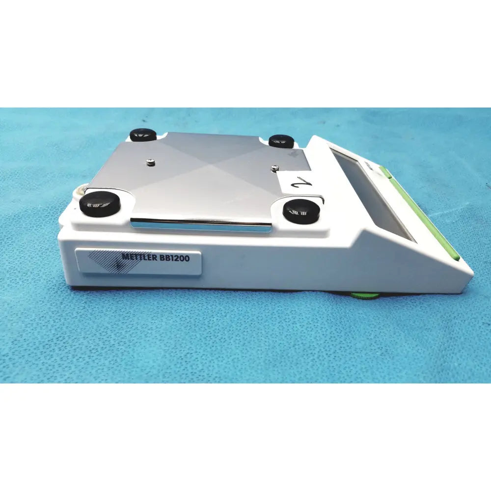 White and silver Mettler BB1200 digital scale laboratory balance with black adjustment knobs for precise measurement