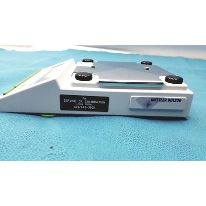 White mettler bb1200 digital scale with black calibration knobs and silver metallic weighing platform for precise lab use