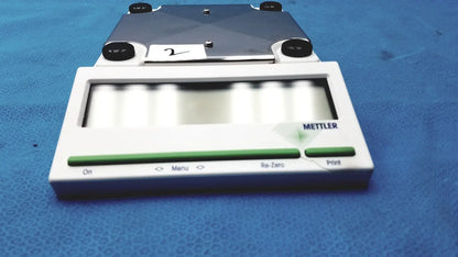 White and green mettler bb1200 digital scale with metallic weighing platform for precise measurements