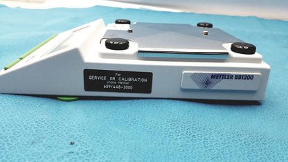 White mettler bb1200 digital scale with black calibration knobs and silver metallic weighing platform for precise lab use