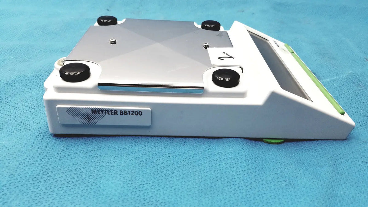 White and silver Mettler BB1200 digital scale laboratory balance with black adjustment knobs for precise measurement