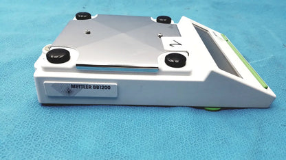 White and silver Mettler BB1200 digital scale laboratory balance with black adjustment knobs for precise measurement