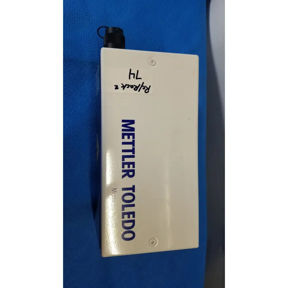 White rectangular mettler toledo haug slc power supply with black threaded cap and blue lettering for industrial use