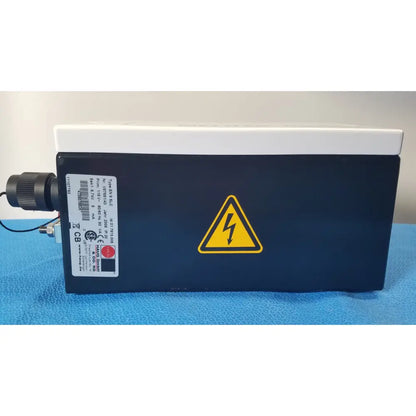 Black rectangular mettler toledo haug slc power supply with white top and yellow lightning bolt warning symbol from hannover