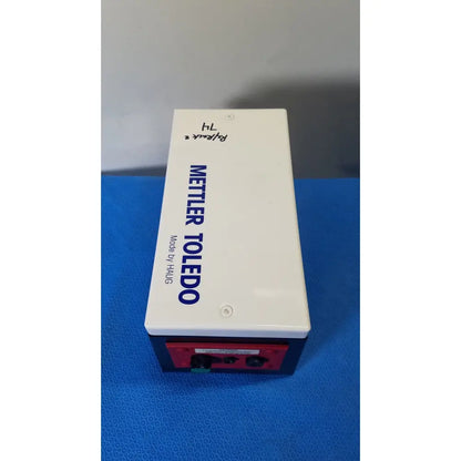 White and red mettler toledo haug en 8 slc power supply battery box with blue text labeling