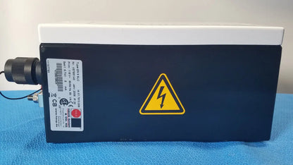 Black rectangular mettler toledo haug slc power supply with white top and yellow lightning bolt warning symbol from hannover