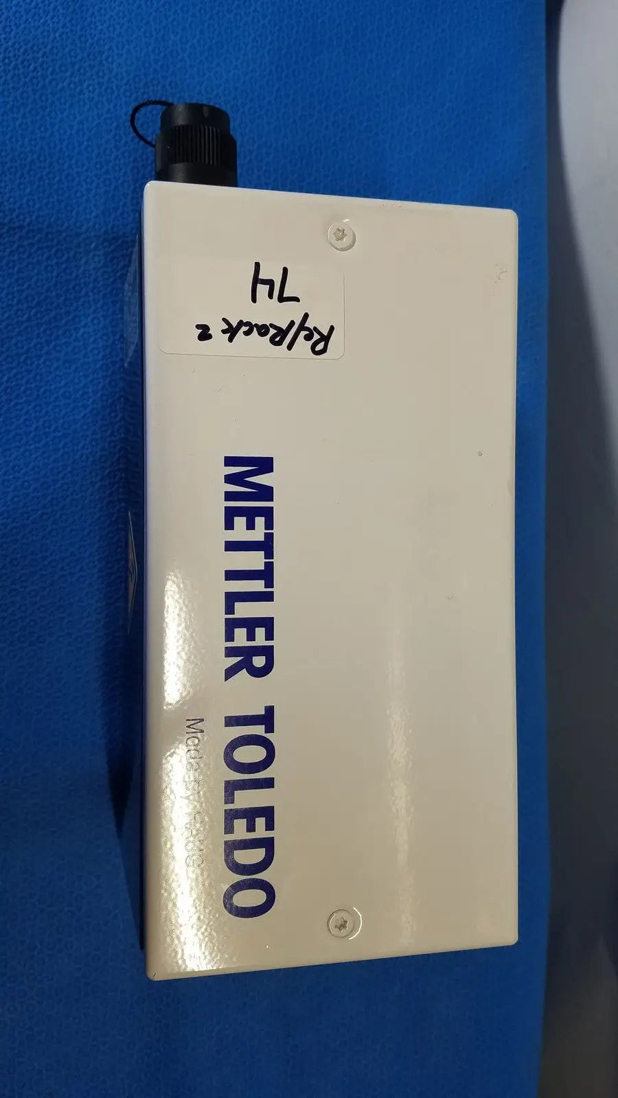 White rectangular mettler toledo haug slc power supply with black threaded cap and blue lettering for industrial use