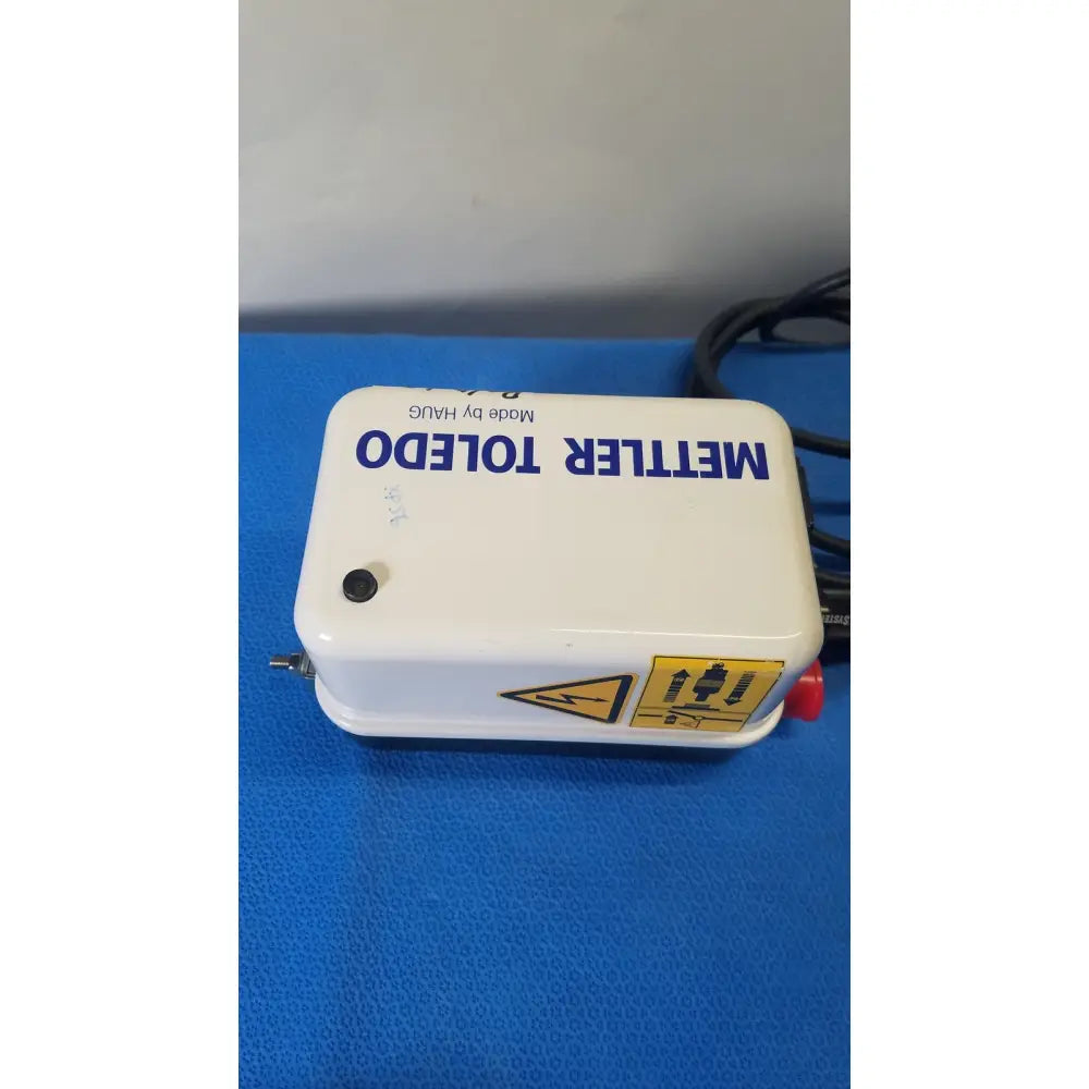 White plastic mettler toledo haug static eliminator bar ionizing power supply with blue lettering and yellow warning label