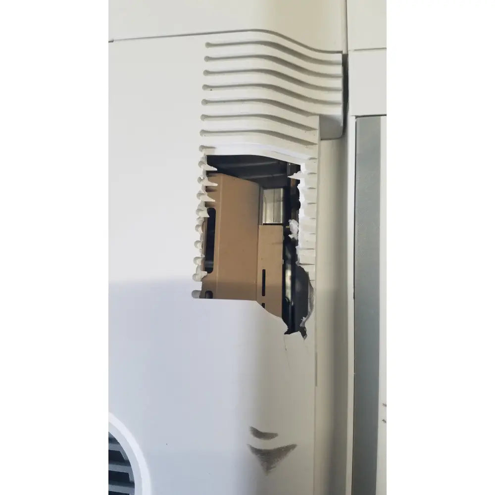 White plastic ventilation grille with wavy ridges showing damage and exposed components on mettler toledo hr83-p halogen moisture analyzer back side
