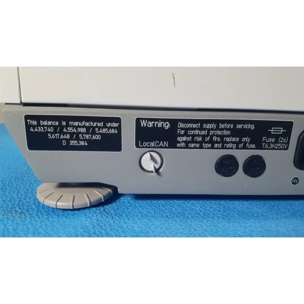 Silver mettler toledo hr83-p halogen moisture analyzer with black label, circular dial, and two round buttons for calibration