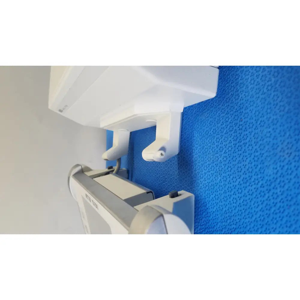 White dental x-ray machine mounted on blue wall shown with mettler toledo umx2 ultra-microbalance scale product