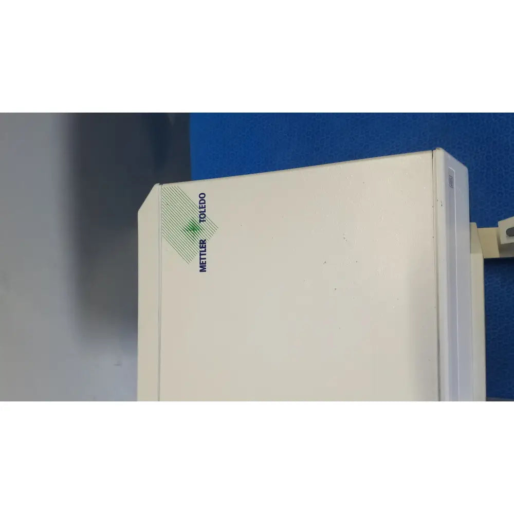 White mettler toledo umx2 ultra-microbalance scale with green and blue branding for precise laboratory measurements