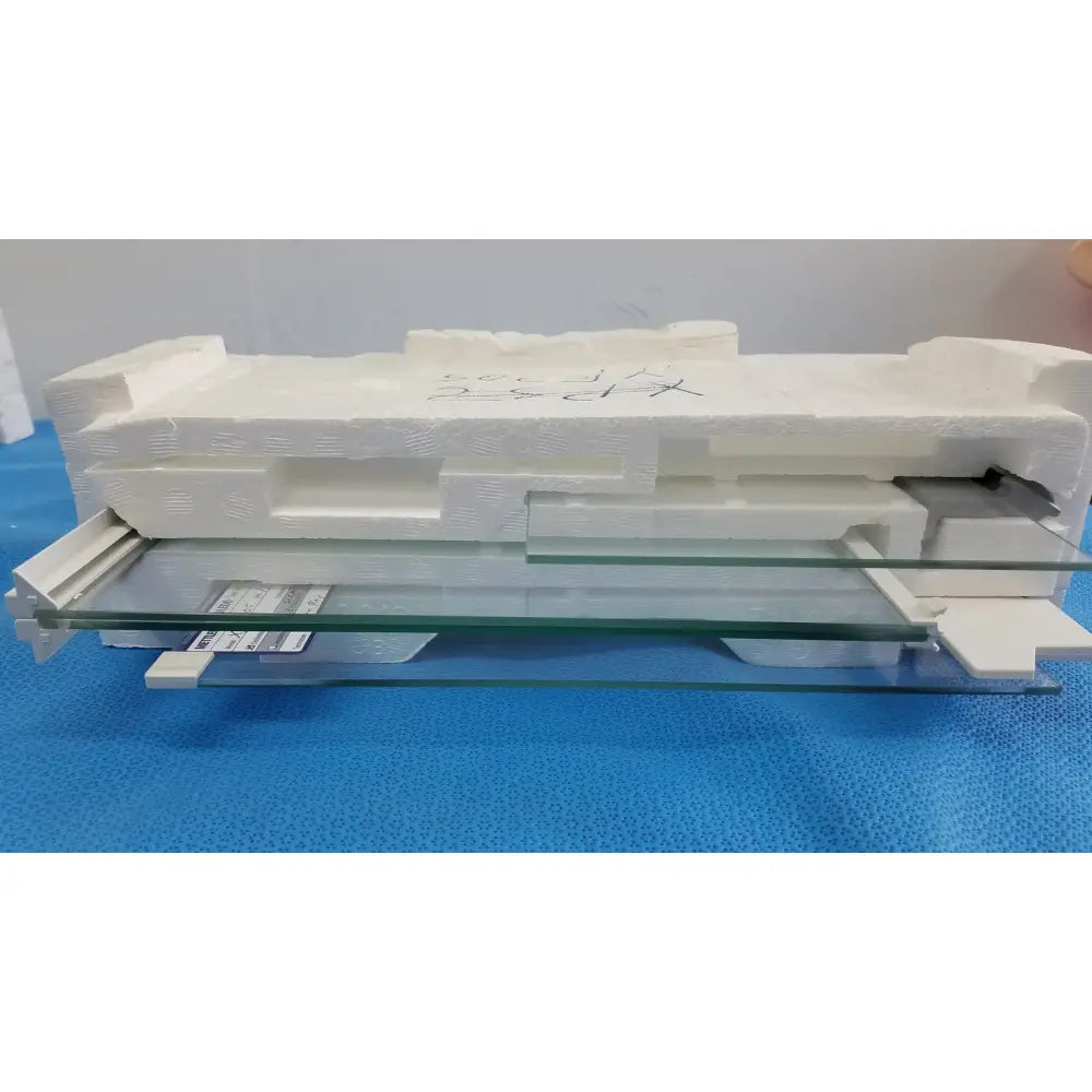 Clear glass panel of mettler toledo xp205 conducting glass draft shield in white foam protective packaging