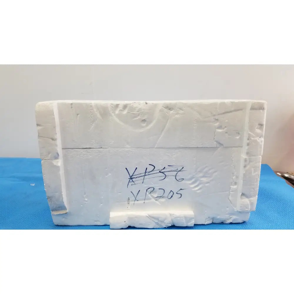 White textured foam block with handwritten markings used as mettler toledo xp205 conducting glass draft shield