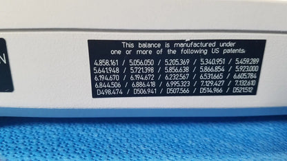 White balance with black patent label showing multiple US patents on the back of mettler toledo xp5003sdr communications module