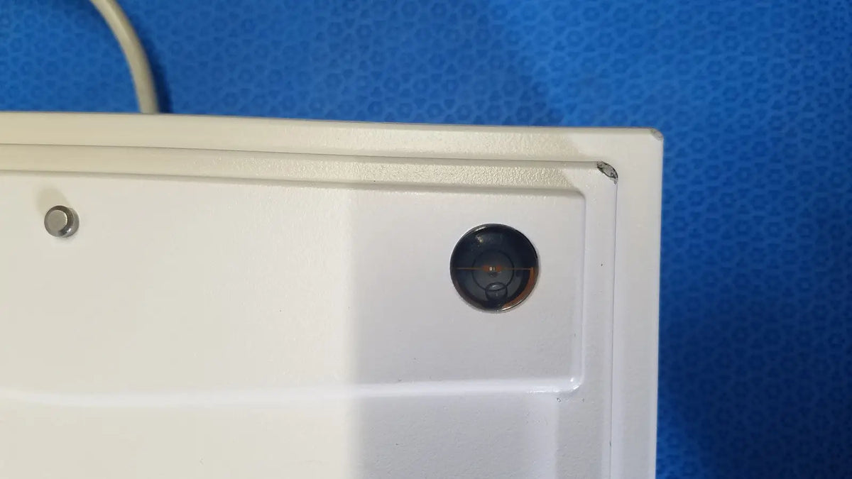 White plastic camera housing with circular recessed lens on mettler toledo xp5003sdr communications module