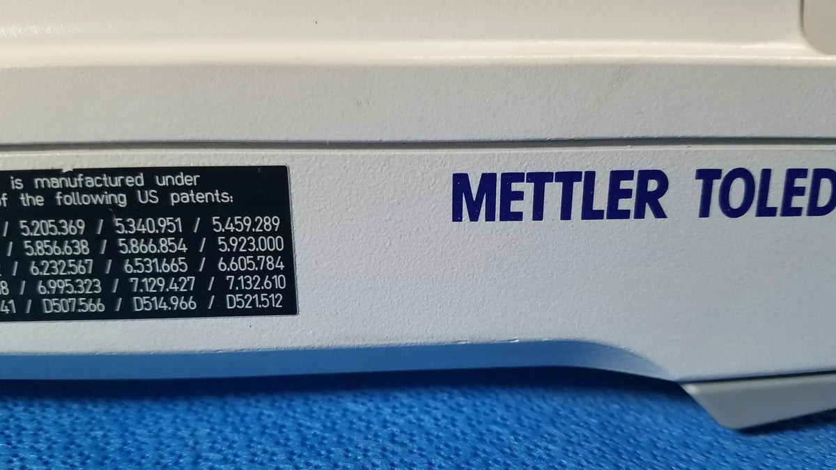 White mettler toledo analytical balance with blue lettering and black patent label for xp5003sdr communications module