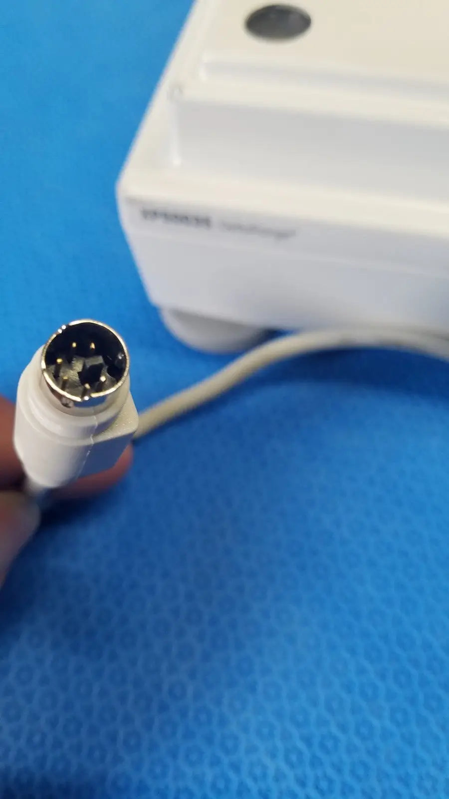 White plastic connector with metallic circular multi-pin plug on the back of mettler toledo xp5003sdr communications module