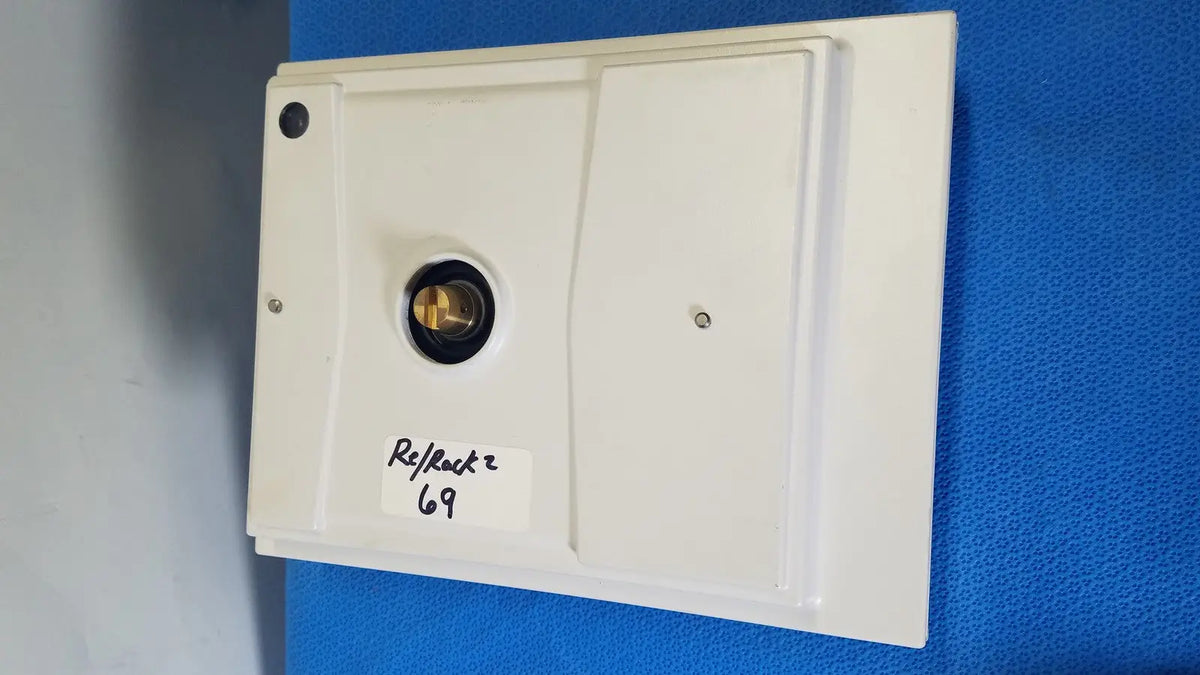 White rectangular mettler toledo xp5003sdr communications module with central brass circular component and two screws
