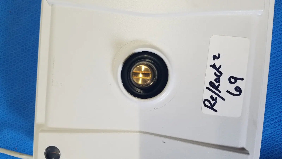 White plastic wall-mounted electrical outlet with brass screw and black rubber grommet for mettler toledo xp5003sdr communications module