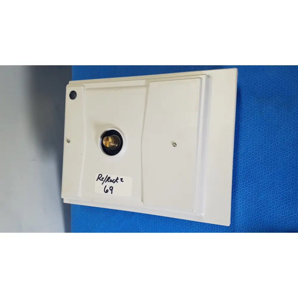 White rectangular mettler toledo xp5003sdr communications module with central brass circular component and two screws