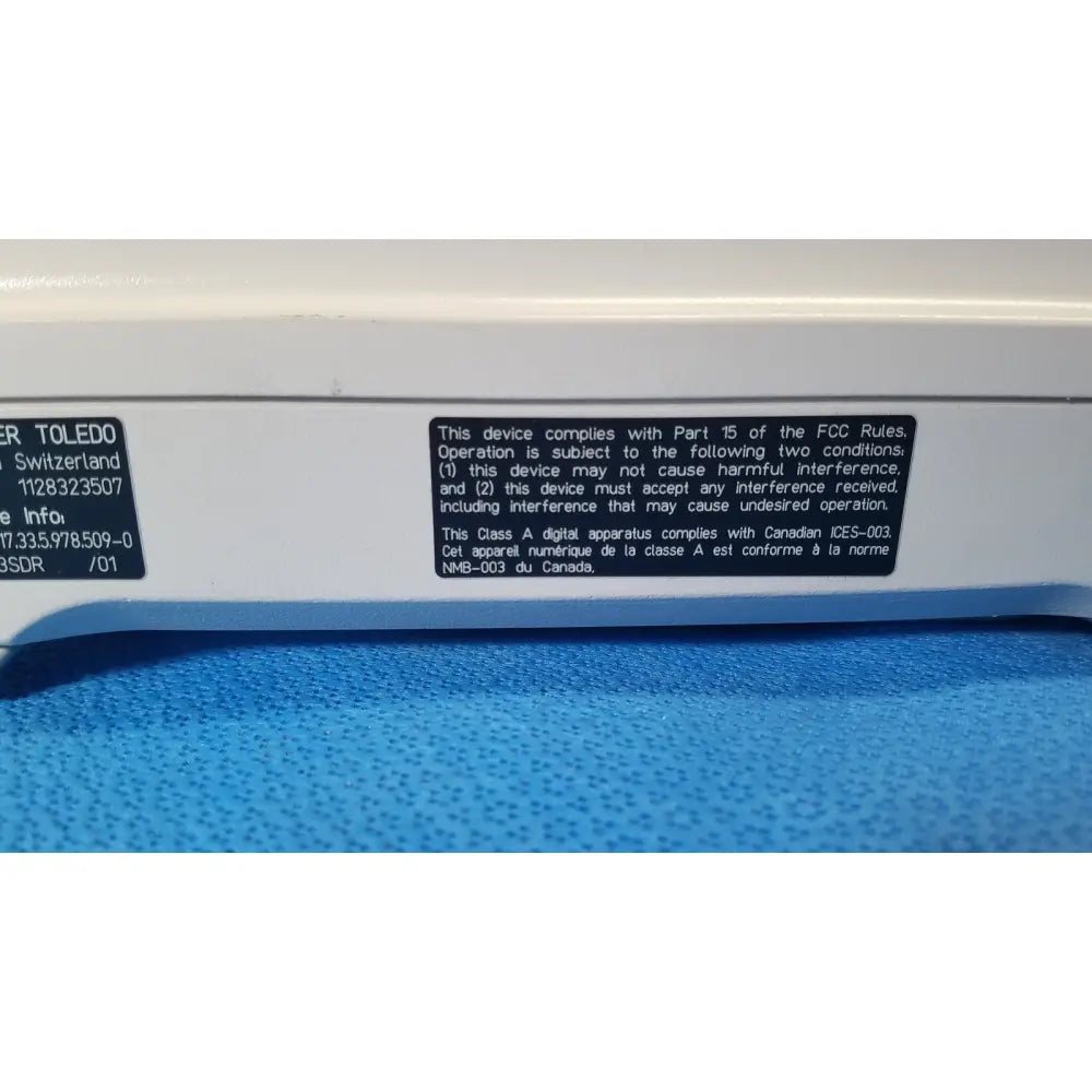 White plastic mettler toledo xp5003sdr communications module with black label showing model number 1128323507 on back side