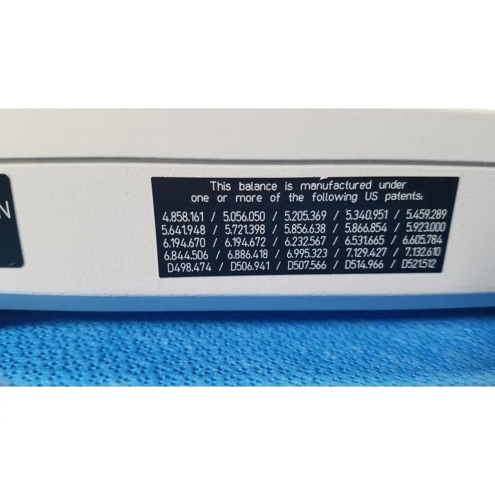 White balance with black patent label showing multiple US patents on the back of mettler toledo xp5003sdr communications module