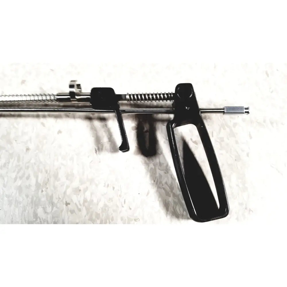 Black plastic-handled surgical retractor with metallic spring and rod mechanism in mhi instruments minilap uterine manipulator