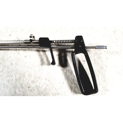 Black plastic-handled surgical retractor with metallic spring and rod mechanism in mhi instruments minilap uterine manipulator