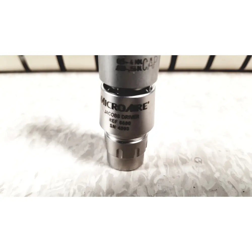 Silver metallic microaire jacobs driver with engraved branding and reference number from microaire surgical instruments set