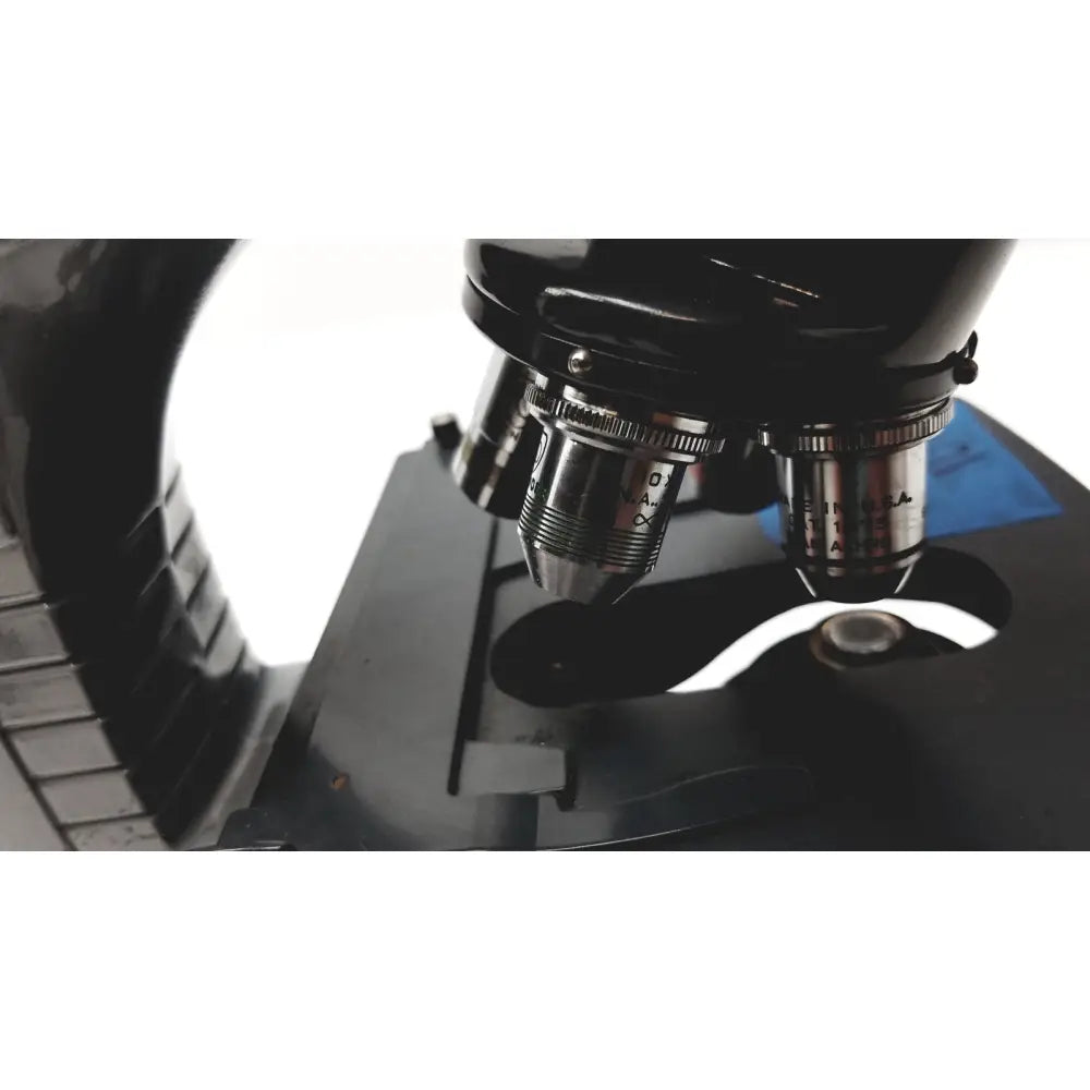 Black microscope american optical spencer with metallic objective lenses and engraved markings for precision use