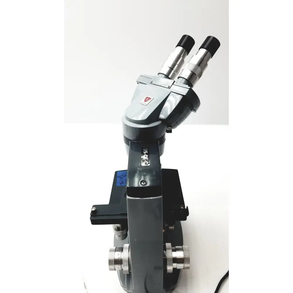 Black and silver dual eyepiece microscope american optical spencer with sturdy metallic body for precision use
