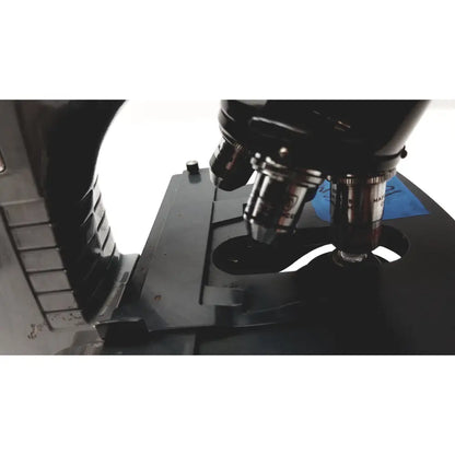 Microscope american optical spencer black metal with silver-tipped objective lenses and blue label on the stage