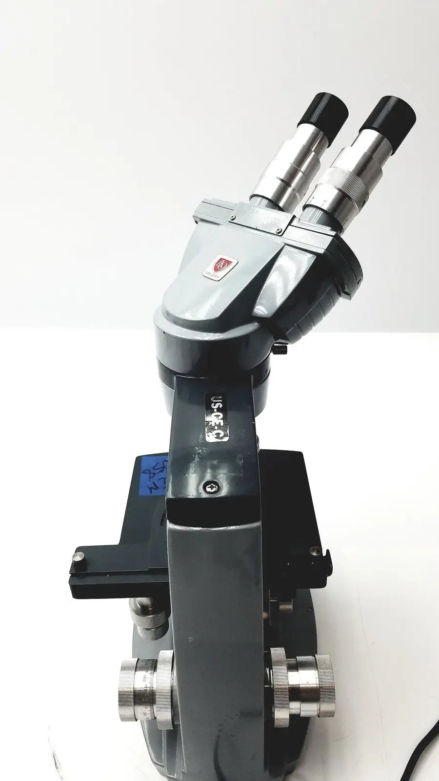 Black and silver dual eyepiece microscope american optical spencer with sturdy metallic body for precision use