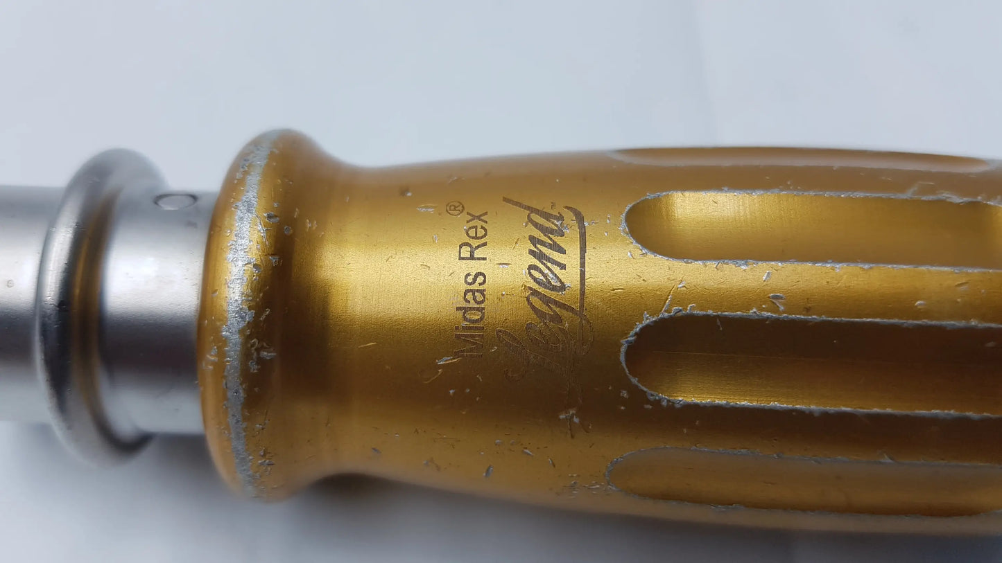 Gold-colored aluminum handle of midas rex legend 1000 RPM AD03 perforator driver with engraved branding and cutouts