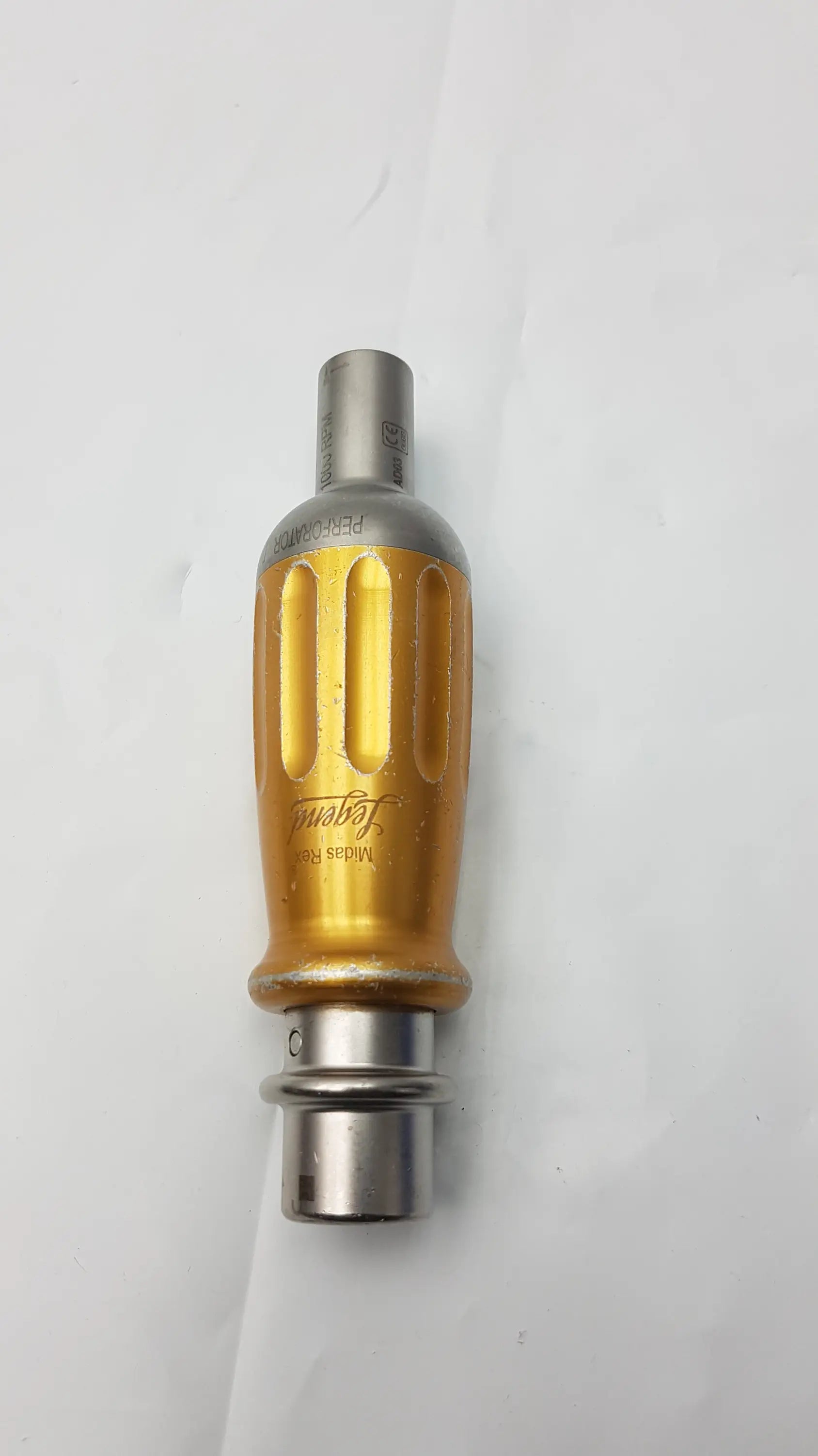Gold-colored textured handle with silver metallic ends and engraved branding on midas rex legend 1000 rpm ad03 perforator driver