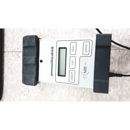 Mie personal dataram real-time aerosol monitor with white body, black rubber grips, digital screen, and green navigation buttons