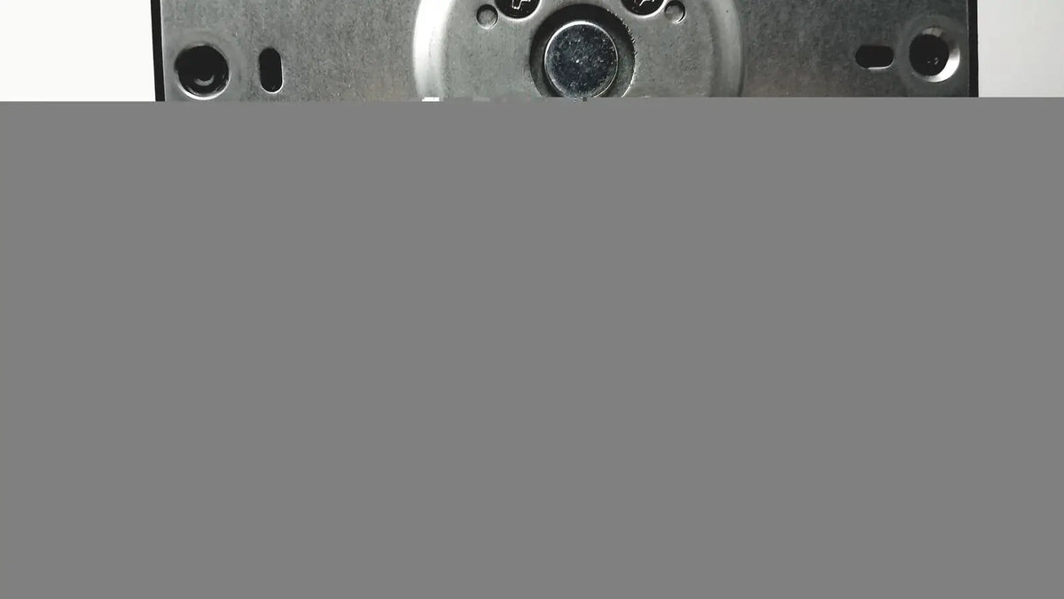 Metallic circular component with multiple holes and central darkened area on the back side of p24h g4 monitor stand