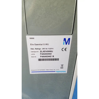 White label with black text and blue logo on gray metallic appliance of millipore elix essential 5 uv water purification system