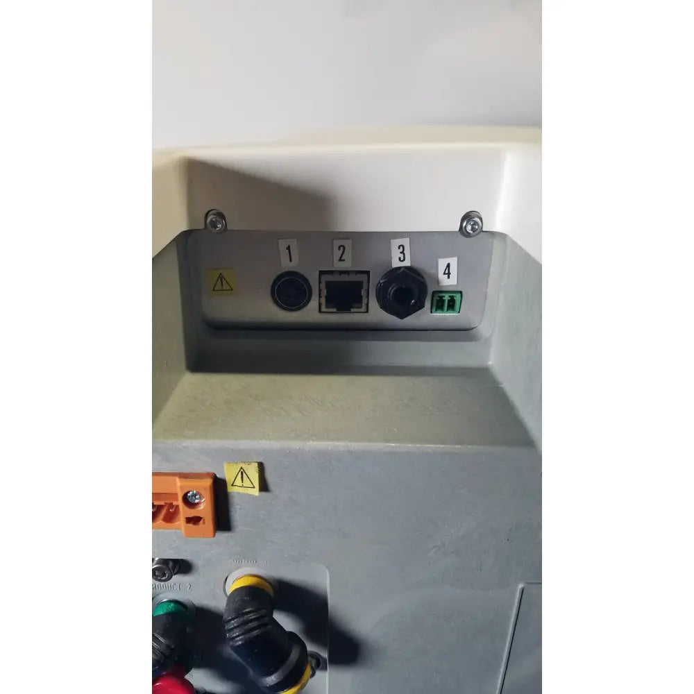 Gray industrial control panel with labeled ports and warning stickers on the back of millipore elix essential 5 uv system