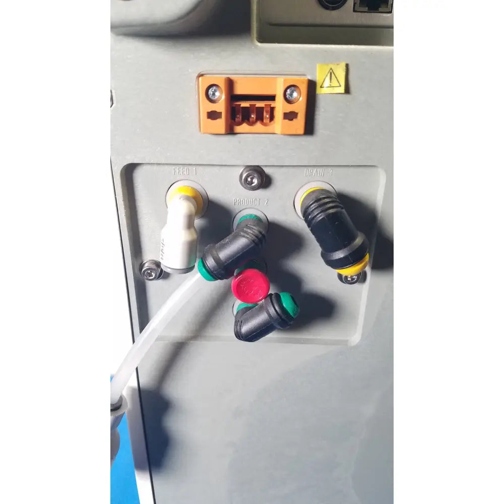 Orange plastic connector with two screws and warning label on the back of millipore elix essential 5 uv water purification system
