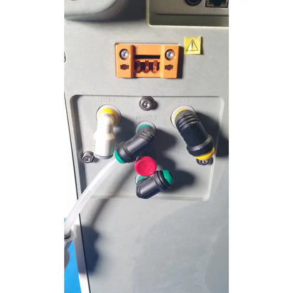 Orange plastic connector with two screws and warning label on the back of millipore elix essential 5 uv water purification system