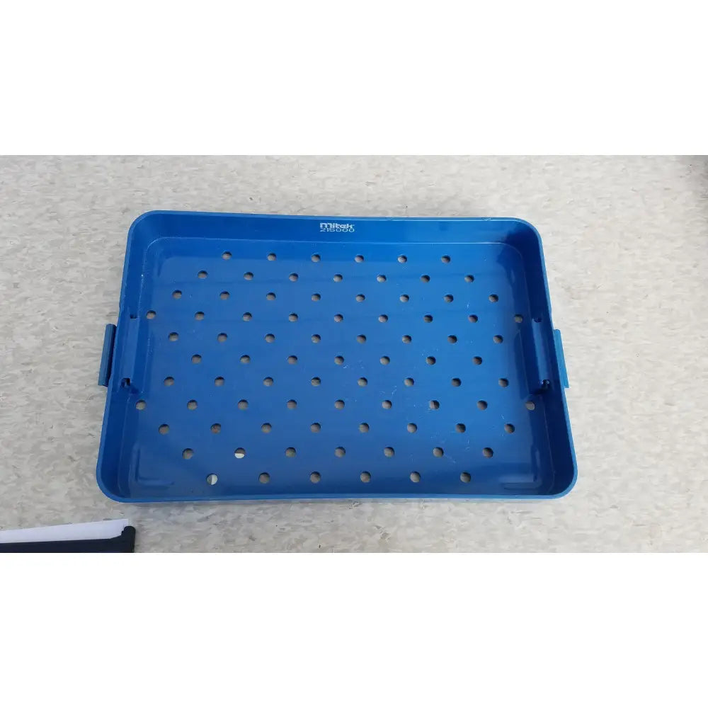 Blue plastic sterilization instrument tray with grid holes and side handles by Mitek Products for instrument sterilization