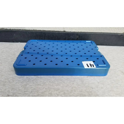 Blue plastic sterilization instrument tray with perforated grid and reinforced corners by mitek products 215000