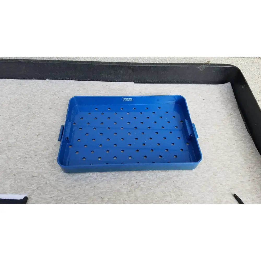Blue plastic sterilization instrument tray with perforated surface and side handles by Mitek Products